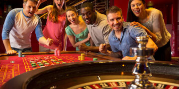 Group Of Friends Playing Roulette In Casino