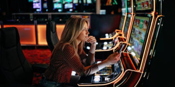 Women gambling on slot machinery