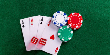 Four aces and gambling chips on the table.