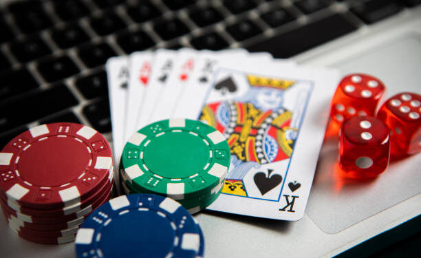 Poker chips and cards on computer keyboard