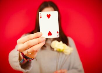 free-photo-of-woman-holding-a-two-of-hearts-card