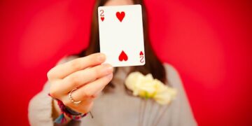 free-photo-of-woman-holding-a-two-of-hearts-card