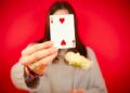 free-photo-of-woman-holding-a-two-of-hearts-card