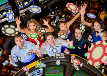 Happy group of people winning at the casino