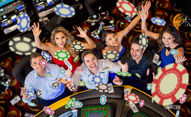 Happy group of people winning at the casino