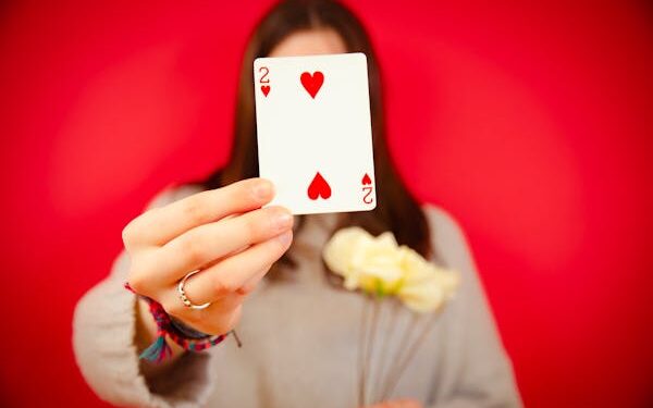 free-photo-of-woman-holding-a-two-of-hearts-card