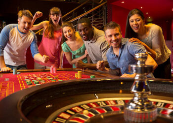 Group Of Friends Playing Roulette In Casino