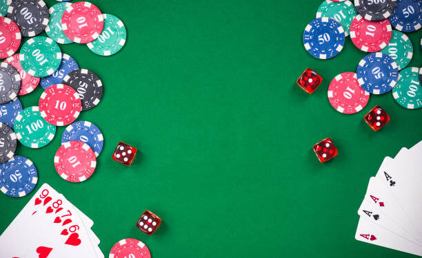 Casino games related items on green table, copy space.