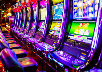 Line of electronic slot machines in casino. Property released.