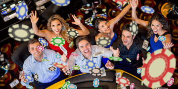 Happy group of people winning at the casino
