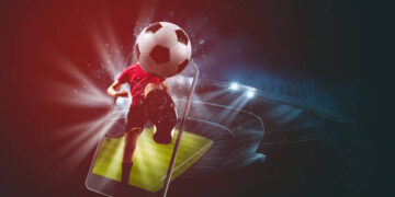 Soccer players, cellphone and ball on a stadium