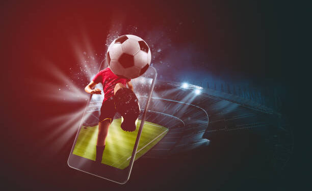 Soccer players, cellphone and ball on a stadium